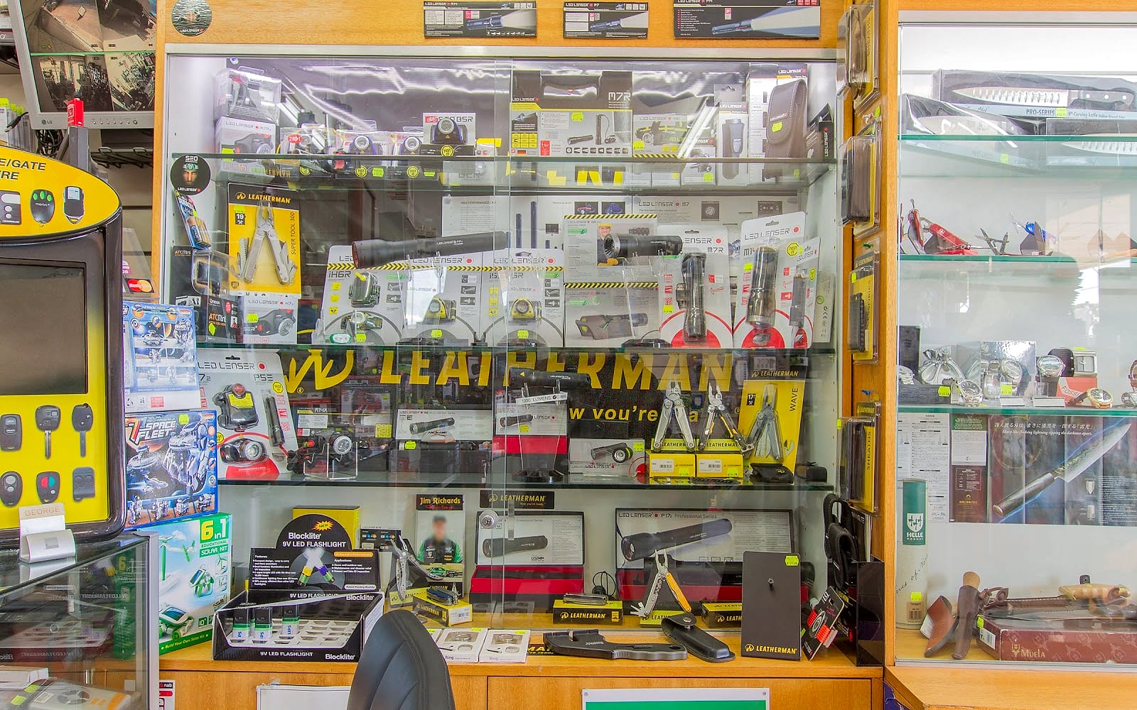 Display cabinets inside The Battery Co, packed with torches, multi tools and watches